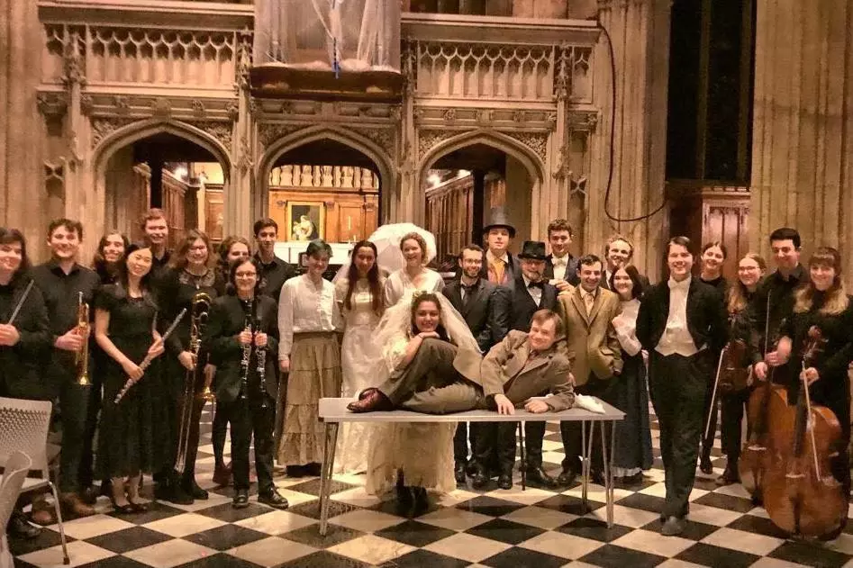 The cast and crew of The Mikado 2022 are assembled in several lines looking towards the camera.