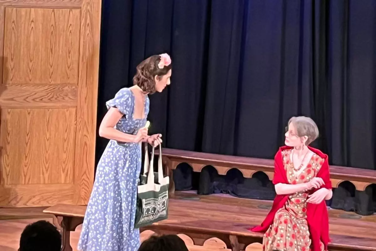 Rose Maybud (standing) discussing ettiquette with Dame Hannah (sat)
